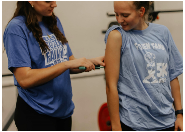 Two students in the Fitness Trainer Technician program working together.