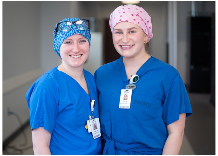 Two Lake Region State College allied health students wearing blue scrubs.