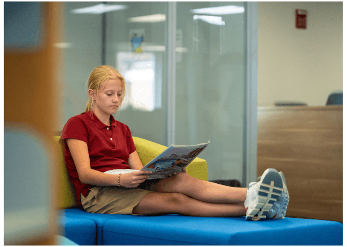 Young student reading in the Learning Commons.