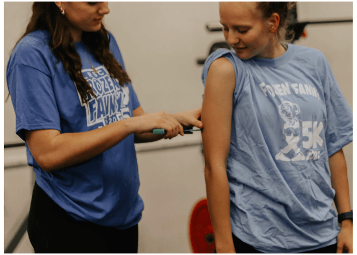 Two students in the Fitness Trainer Technician program working together.