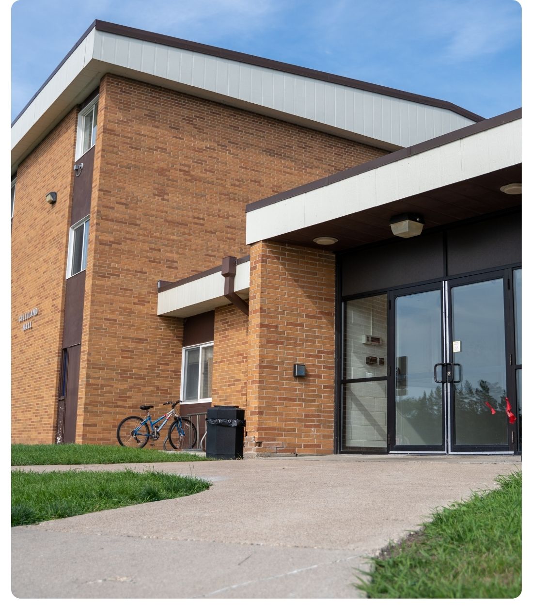 Exterior view of Gilliland Hall, a Lake Region State College residence hall, showing the brick building and main entrance.