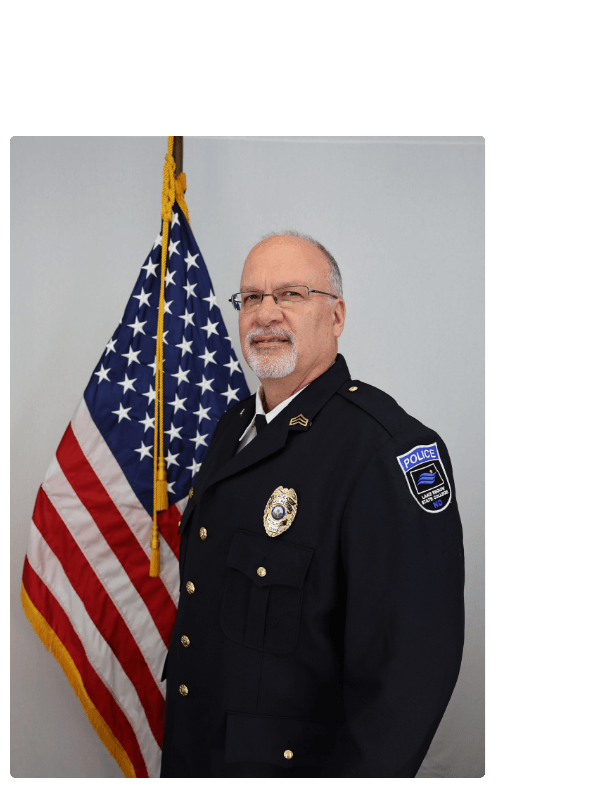 Sgt. Jim Remer headshot by the American flag. 