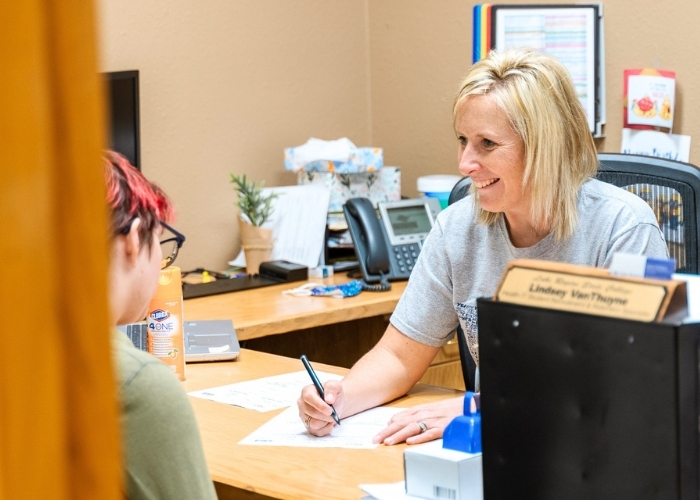 Female advising an LRSC student in her office. 
