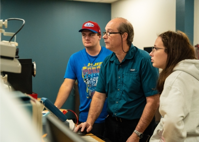 Instructor teaching two students. 