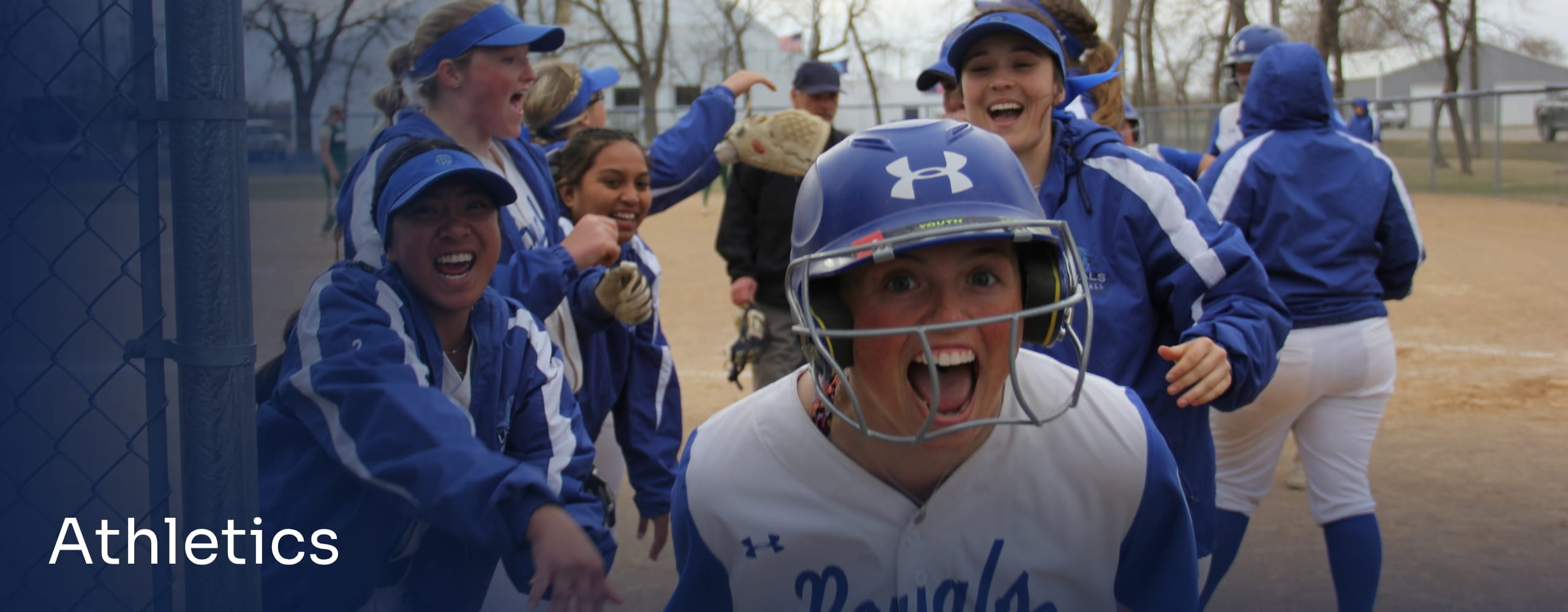 Picture of LRSC softball players celebrating.
