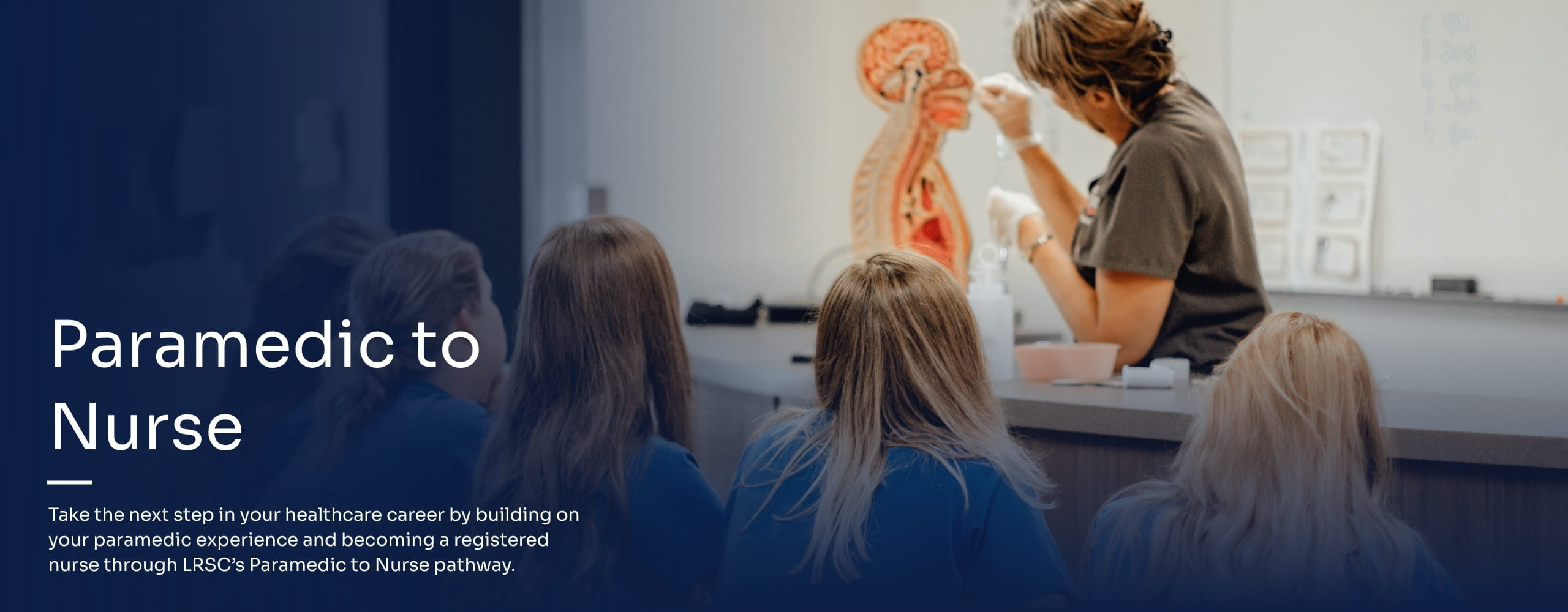 Nursing instructor teaching in front of a class.