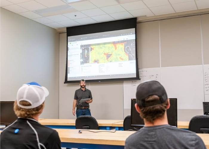 Instructor presenting software to students in an agriculture classroom.