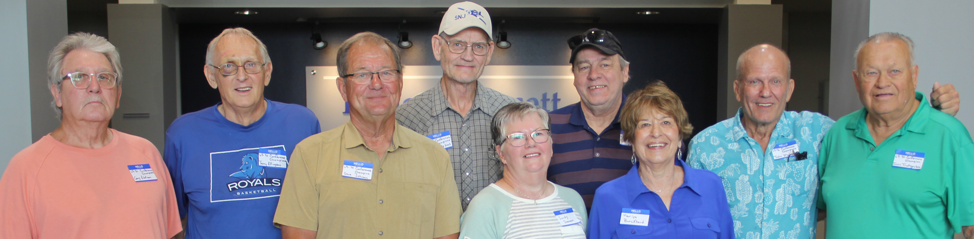 members of the 1969-1970 men's basketball team, cheerleader, and head coach's wife