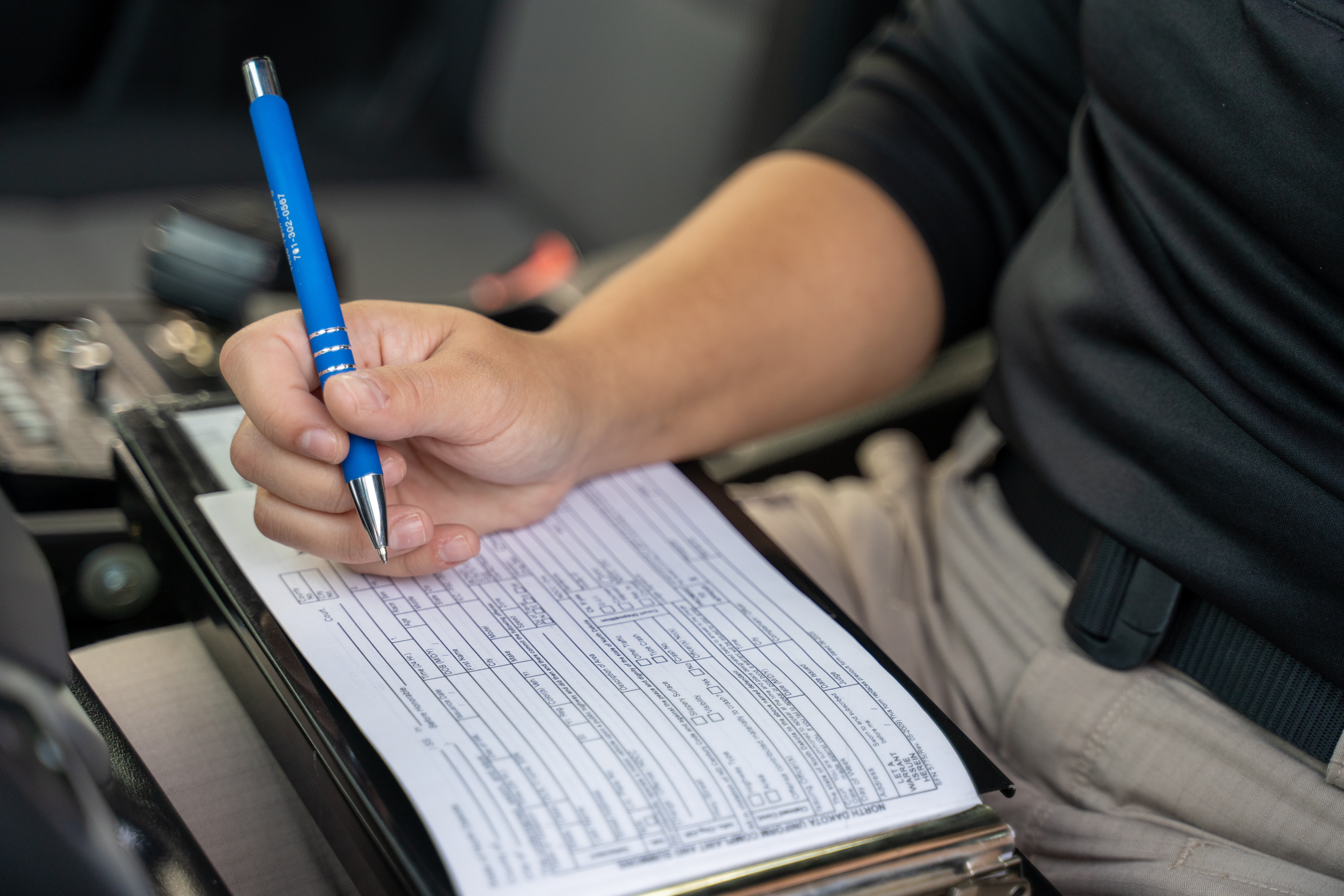 officer writing out a ticket