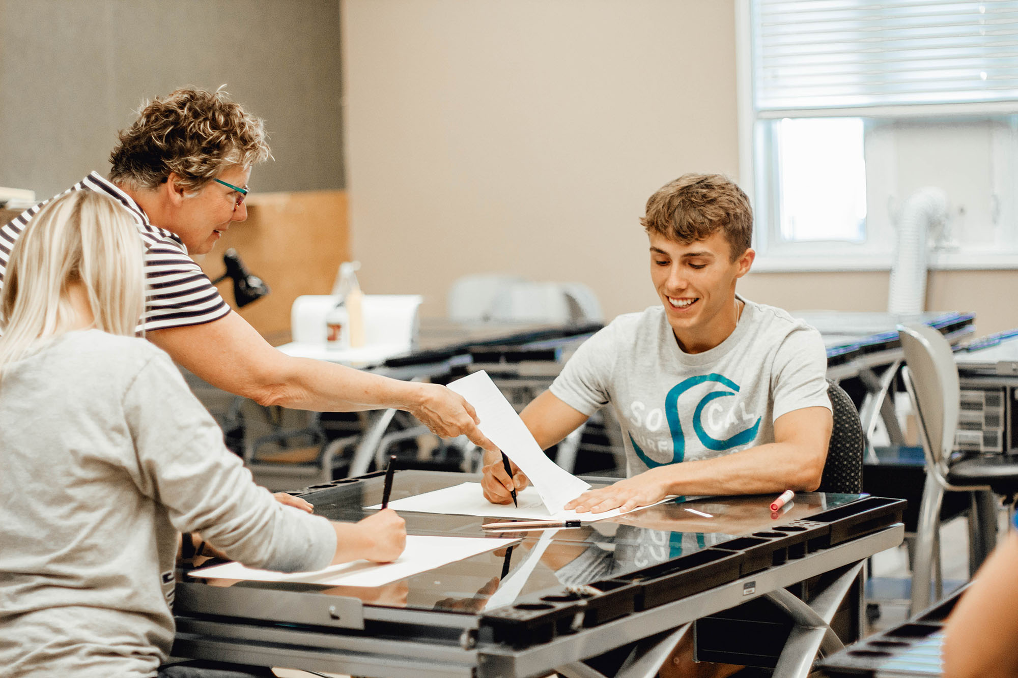 LRSC Art Instructor Deb Carlson with students