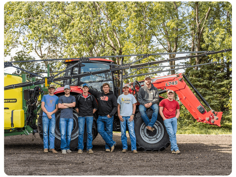 LRSC students posing in front of a tractor.