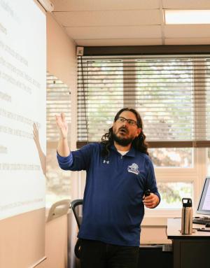 Male with beard teaching