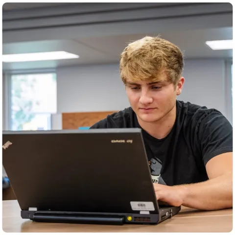 Student on his computer. 