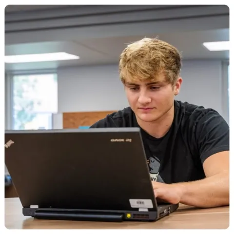 LRSC student on a computer in the Learning Commons.