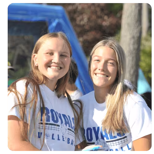 LRSC Royals volleyball students wearing team shirts outdoors.
