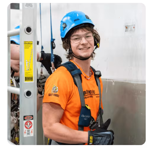 LRSC WIND student wearing safety helmet and harness during wind energy training.