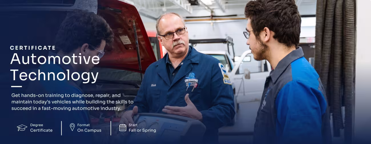 Automotive Technology instructor teaching two students in a shop.