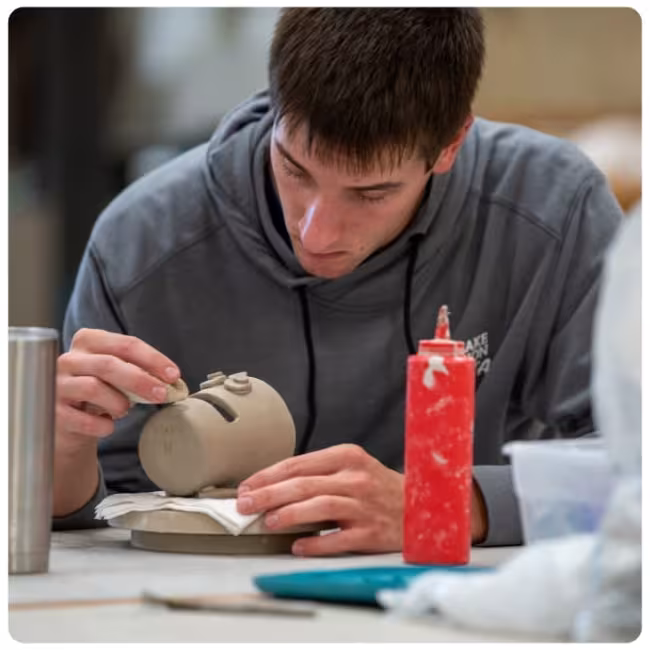 Graphic of an Art student working on a project. 