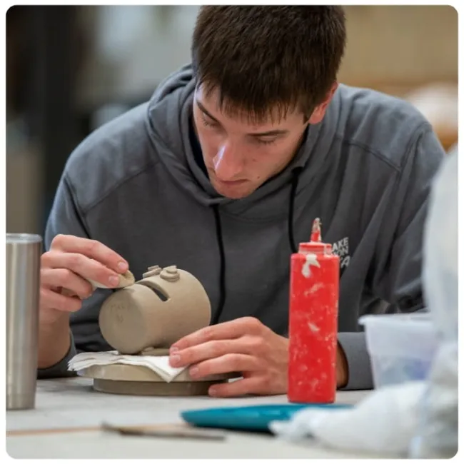Graphic of an Art student working on a project. 