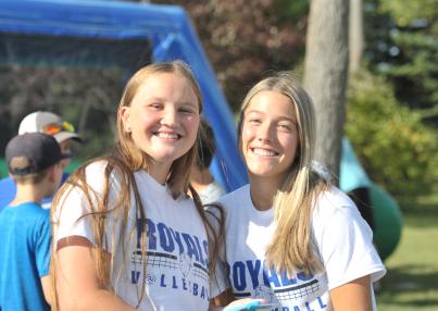 Two female co-eds pose at outdoor gathering at LRSC